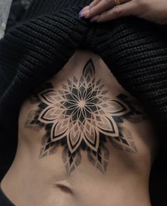 a woman with a tattoo on her stomach