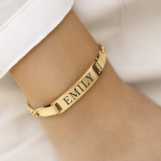 Celebrate your unique identity and style with our Custom Engraved 18k Gold Plated Bracelet. This delicate and elegant bracelet features a sleek gold bar that can be engraved with the name of your choice, making it a perfect personalized accessory or thoughtful gift for a loved one. Whether you're treating yourself or surprising someone special, this bracelet adds a touch of sophistication to any outfit. The bar measures a generous 30mm x 4mm, providing ample space for a clear and stylish engravi Classic Gold Name Bracelet, Personalized Nameplate Gold Bracelet For Formal Occasions, Classic Gold Name Bracelet For Anniversary, Classic Gold Bracelet With Name For Anniversary, Classic Gold Plated Name Bracelet, Elegant Engraved Gold Chain Bracelet, Classic Adjustable Gold Bracelet With Name Detail, Classic Adjustable Gold Bracelet With Name, Personalized Classic Gold Bangle Bracelet