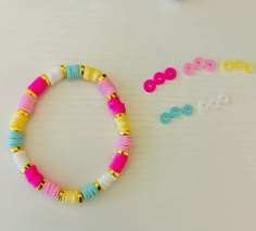 the bracelet is made from plastic beads and has two pairs of buttons attached to it