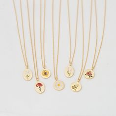 "These beautiful and dainty flower collection disk necklaces are made from 18ct gold plated metal, the pendants show different designs, choose your favorite flower your heart desires.. This is the perfect gift for you and your loved ones.❤ D E T A I L S * Delicate floral designs on circle or oval shaped disks * Each flower indicates; ▸ Lily (oval): purity & devotion ▸ Carnation (oval): love & gratitude ▸ Sunflower: loyalty & good fortune ▸ Daisy: hope & peace ▸ Tulip (oval): perf 14k Gold Filled Flower Necklace, 14k Gold-filled Flower Necklace, Dainty Round Disc Charm Necklace For Gift, Dainty Flower Pendant Necklace As Gift For Mom, Dainty Round Disc Charm Necklace As Gift, Dainty Flower Necklaces For Mother's Day, Delicate Necklace With Flower Charm And Round Pendant, Flower Charm Necklace Gift, Dainty Flower Necklace For Mother's Day