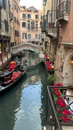 two gondola boats are parked on the side of a canal