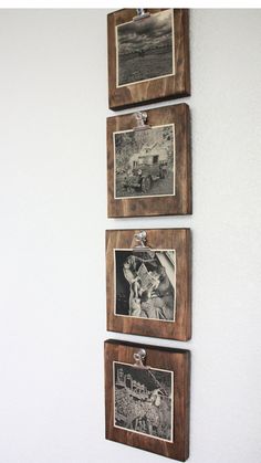 three wooden frames hanging on the wall with pictures pinned to them and magnets attached