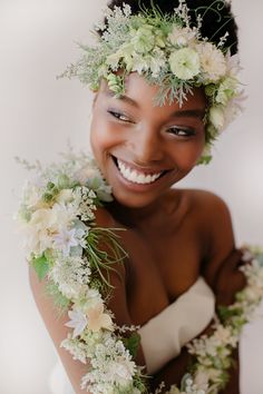 a woman with flowers in her hair smiling