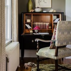 a room with a desk, chair and bookshelf