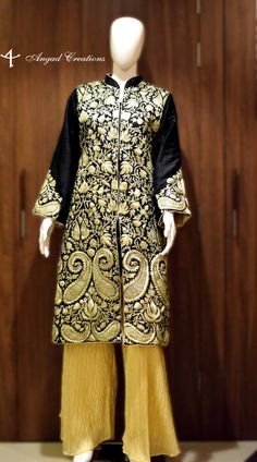 Get a polish look with this Jacket. Pair it up with a skirt, trousers, dress or even a flowing maxi and get ready in style.Product Details- Condition: Brand New (Made to order)- Fabric: Pure Raw Silk - Base Color of Coat: Black- Embroidery Color: Golden Zari/Tilla Embroidery- Fully Lined from Inside- Features Pockets on both sides.- Length: 42" (107 cms approx, the display mannequin is 6ft tall).- Care Instructions: Dry Clean Only.**If you want the coat to be shorter or longer, just send us a me Gold Long Sleeve Nehru Jacket With Chikankari Embroidery, Fitted Long Sleeve Traditional Wear With Gold Embroidery, Elegant Designer Winter Outerwear, Designer Long Sleeve Outerwear With Chikankari Embroidery, Traditional Embroidered Blazer For Festive Occasion, Traditional Long Sleeve Embroidered Blazer, Long Sleeve Nehru Jacket With Gold Embroidery For Winter, Fitted Stand Collar Outerwear With Intricate Embroidery, Black Embroidered Sets For Fall