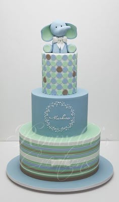 a three tiered cake with an elephant on top