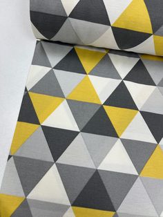 a yellow and grey triangle pattern on fabric