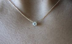 "This classic necklace features a round floating diamond basket set. Beautiful solitaire diamond necklace, perfect for a sparkly everyday look. *4 mm= .25 carats approximately. *4.4 mm= .33 carats approximately. *4.8 mm= .40 carats approximately. * Handmade in the USA. * Gold KT: 14K/18K gold. * Diamonds: Round Diamond * Color and Clarity: H (or better) / SI2 (or better). * Chain type: 1 mm cable chain, Lobster clasp. * Chain length: 15\"-16\", 17\"-18\". * Setting Type: Basket Setting. * Made t Timeless 14k Gold Solitaire Diamond Necklace, Timeless Everyday Solitaire Necklace With Prong Setting, Timeless Solitaire Diamond Necklace In 14k Gold, Timeless Solitaire Necklace For Everyday, Timeless Everyday Solitaire Necklace, Classic Diamond Necklace With Prong Setting For Everyday, Classic 14k Gold Solitaire Necklace With Single Cut Diamonds, Classic Everyday Diamond Necklace With Prong Setting, Elegant 14k Gold Solitaire Round Necklace