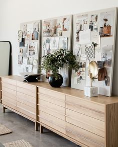 a wooden dresser topped with lots of pictures and plants