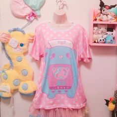 "Is a nurse bear taking care of her patient. The word in japanese means \"PAIN\" This new all over print t-shirt features a relaxed fit for Cuties. Made of 100% mesh cloth, this t-shirt is durable, breathable and soft. * 7.05 Oz. 100% polyester. * Double-needle hemmed sleeves and bottom. * Machine wash cold. The print on garment body is unable to fade. Color may appear different in the photo. Thank you'ω ♥ ☆ ★ ♪ Model by: katiebabydoll" Shoulderless Shirt, Word In Japanese, Pastel Accessories, Kawaii Shirt, Kawaii Shirts, Yami Kawaii, Kawaii Accessories, Style Savvy, Japanese Words