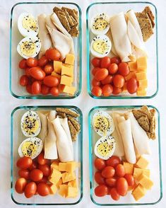 four glass containers filled with different types of food and veggies on top of each other