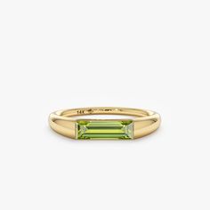 Capture the essence of August with the Natural Peridot Ring, a radiant symbol of summer's warmth and vitality. Crafted in your choice of 14k or 18k solid gold, this ring showcases a vibrant green peridot, the birthstone for August, elegantly displayed in a modern channel setting. Its understated design and timeless beauty make it a perfect addition to any jewelry collection. - Handmade - Solid Gold - Natural Peridot - Total Peridot Carat Weight: 0.93 ctw - Height of the Setting: 2.9 mm - Ring Thickness: 3.47 mm 🛠 Your Sarah Elise piece is handcrafted with care! Ready-to-ship items go out within 3 business days. Made-to-order pieces typically take 7-10 business days to create. If you need something sooner, please contact us - we'll see if we can make it happen! For estimated shipping dates Ring Baguette, Solid Gold Bracelet, Channel Setting, August Birthstone, Beautiful Gift Wrapping, Initial Ring, Peridot Ring, Name Jewelry, Initial Jewelry