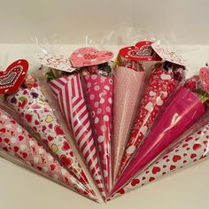 a bunch of paper umbrellas with hearts on them