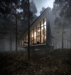 a house in the middle of a forest at night with lights shining on it's windows