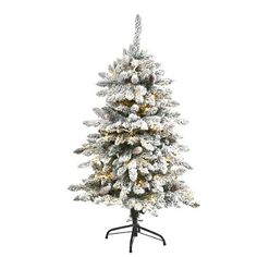 a white christmas tree with snow on it's branches and an upside down stand