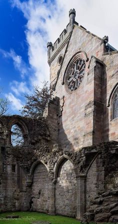 an old stone building with a clock on it