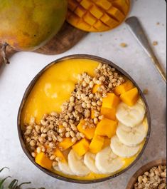 a bowl filled with fruit and nuts on top of a table next to other fruits