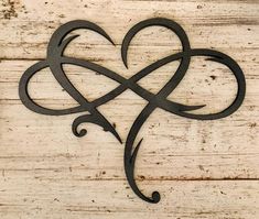 a heart shaped metal object sitting on top of a wooden table