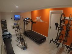 a home gym with treadmills, exercise bikes and other personal items in the room