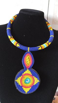 African Beaded Pendant Necklace,  Zulu Necklace, African Jewelry, Women Jewelry, Gift for her, Tribal necklace, Moms GiftThis pendant  necklace is superbly crafted.Main Color - Dark blue.Different colors can be available.Feel free to send me a convo or e-mail for any clarification or more information.Thank you for visiting and happy shopping! Blue Beads Choker Jewelry, Traditional Blue Choker With Colorful Beads, Blue Polished Bead Pendant Jewelry, Traditional Blue Beaded Choker Necklace, Blue Beaded Round Pendant Jewelry, Traditional Blue Beaded Choker, Blue Beaded Necklaces As Gift, Unique Blue Choker Jewelry, Traditional Blue Choker For Gift