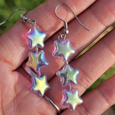 Y2k 1990s Vintage Holographic Iridescent Transparent Purple Stars Dangling Earrings So Beautiful! A Stack Of Three Iridescent Holographic Purple Hued Plastic Stars With One Bead Between The Top And Bottom Two. Fun, Y2k 90s Vintage! French Wire Hooks. No Precious Metals. Never Worn. Tags: Native American, Southwestern, Western, Jewelry, Ranch Girl, Vintage, Tribal, Aztec, Hippie, Boho, Bohemian, Gypsy, Moon Child, Desert, Country Girl, Cowgirl, Cowboy Farm Girl, Horse Lover, Turquoise Rodeo Queen Kawaii Accessories Jewelry, Funky Earrings Vintage, Bisexual Jewelry, Silly Earrings, Ranch Girl, Holographic Accessories, Rave Jewelry, Pride Accessories, Holographic Fashion