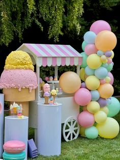 an ice cream stand with balloons and other decorations