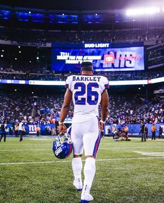 a football player is walking on the field