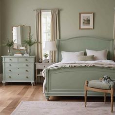 a bedroom with light green walls and white bedding, dressers, and mirror