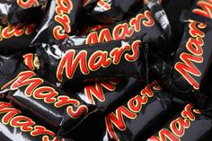 a pile of mars chocolate bars sitting on top of each other