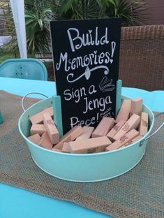 a bucket full of wine corks sitting on top of a blue cloth covered table