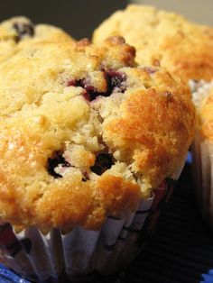 two muffins sitting on top of a blue and white plate next to each other