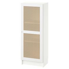 a white cabinet with brown dots on the front and bottom panel, against a white background