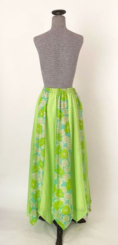 "60s lime green mod print maxi skirt with zig zag hem. Fully lined with sheer shell, alternating polka dot and floral panels and a stretchy elastic waistband. Condition: some spotting inside the lining around the waistband area with a couple small spots on the shell and minor seam-wear on the waistband -- please see photos. Overall great vintage condition. All measurements are taken with the garment laying flat and doubled for the bust, waist, and hips. Waist: 27\" - 30\" elastic waist Hips: 50\ Green A-line Maxi Skirt For Spring, Green A-line Maxi Skirt For Summer, Green Cotton Lined Maxi Skirt, Retro Green A-line Skirt, Green Cotton Maxi Skirt With Lining, Green Flowy Cotton Maxi Skirt, Green Lined Maxi Skirt For Spring, Green Full Maxi Skirt For Summer, Green Cotton Full Maxi Skirt