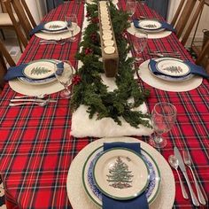 the table is set for christmas dinner with red, white and blue plaid linens