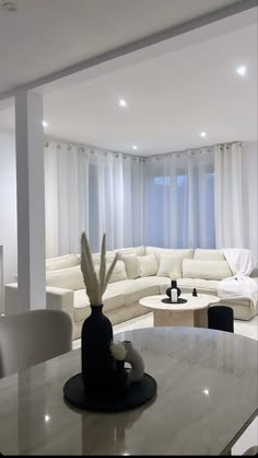 a living room filled with furniture and white walls