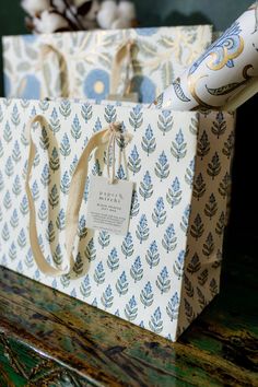 a gift bag sitting on top of a wooden table