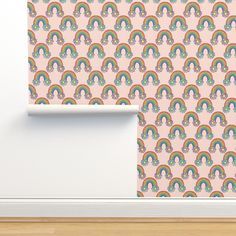 a pink wallpaper with rainbows and clouds on the bottom, in front of a white door