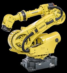 a yellow robot is sitting on top of a machine