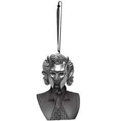 a metal head hanging from a string with a black tie on it's neck