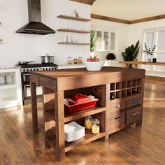 the kitchen island is made out of wood and has drawers on both sides that hold dishes