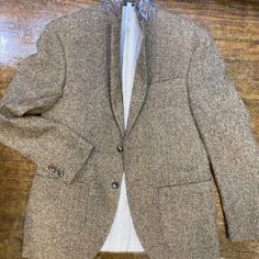 Tan Herringbone Fabric. This Is A Go To Piece. Easy To Wear And Matches With Everything. Two Button, Two Vents. Fully Lined. Pale Blue Lining With Red Trim. 50% Wool, 30% Poly, 20% Cotton. Inside Phone Pocket. Patch Pockets. Paisley Lining Under Collar. Beige Long Sleeve Tweed Jacket For Semi-formal Occasions, Brown Tweed Jacket With Single Button, Fitted Beige Tweed Jacket With Pockets, Brown Single Button Long Sleeve Tweed Jacket, Semi-formal Beige Long Sleeve Tweed Jacket, Fitted Beige Outerwear With Welt Pockets, Classic Beige Tweed Jacket With Pockets, Beige Single Breasted Tweed Jacket With Notch Lapel, Beige Tweed Lapel Collar Jacket For Semi-formal Occasions