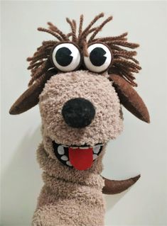 a stuffed dog has big eyes and is smiling