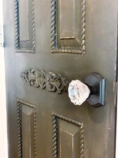 an ornate door handle on the side of a metal door