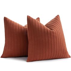 two brown pillows sitting on top of each other