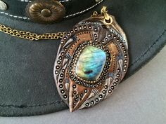 "\"For Becky\" is a hand tooled leather fantasy pendant in bronze palette with spectacular rainbow labradorite cabochon in the middle. This one of a kind piece would drag attention to the place where it hangs ;) Listing includes a bronze or copper chain, thus please provide me with the desired length and choice upon purchase. Your parcel will be sent by priority airmail service. This particular pendant was MADE TO ORDER but it's just one of many more I can make. If you would like me to customize Bronze Cabochon Bohemian Jewelry, Bronze Bohemian Jewelry With Cabochon, Bohemian Bronze Cabochon Jewelry, Bronze Bohemian Cabochon Jewelry, Bohemian Labradorite Collectible Jewelry, Artisan Bronze Labradorite Necklace, Artisan Labradorite Bronze Necklace, Bronze Bohemian Necklace With Cabochon, Handmade Brown Labradorite Jewelry