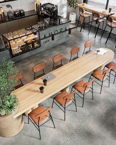 an overhead view of a table and chairs with laptops on it in a restaurant