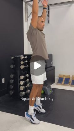 a man in grey shirt and white shorts doing squat exercises