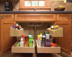 an open drawer in a kitchen filled with cleaning products