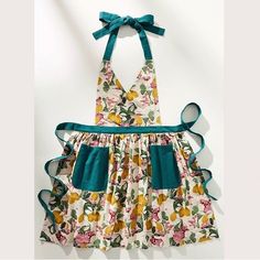 an apron dress with flowers and blue ribbon