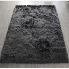 a large rug with dark grey fur on the floor